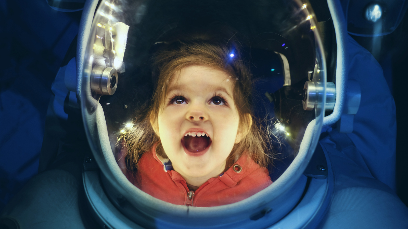 Young Child Exploring Space Suit