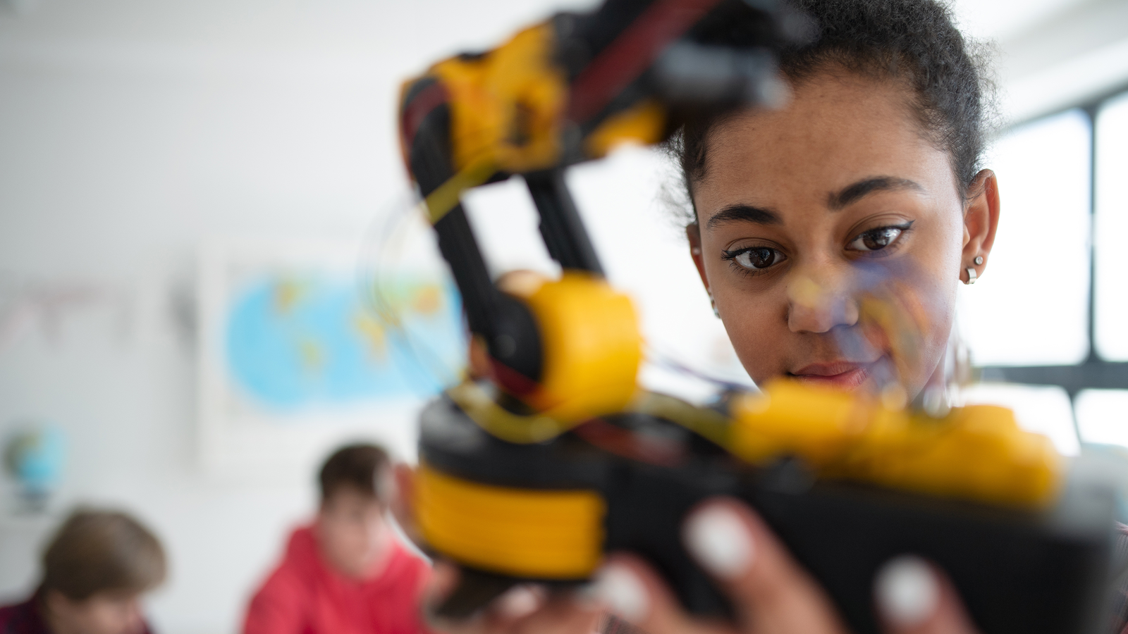 Teen playing with robotics in class