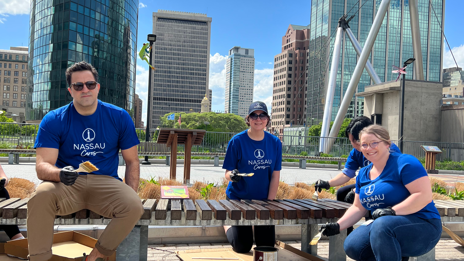 Group of volunteers painting bench