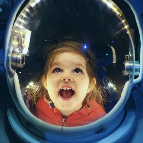 Young Child Exploring Space Suit