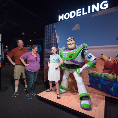 Family posing with Buzz Lightyear