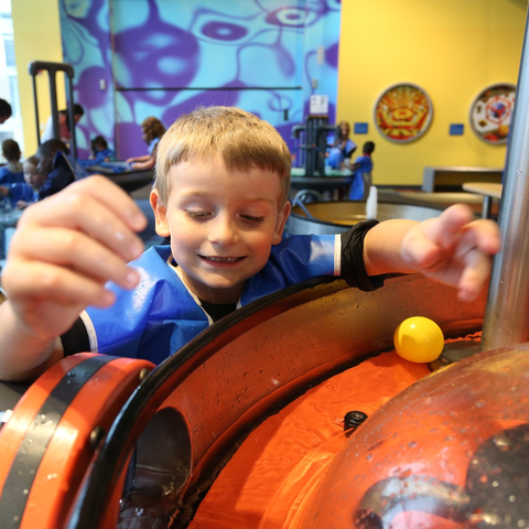KidSpace - Boy playing with watertable