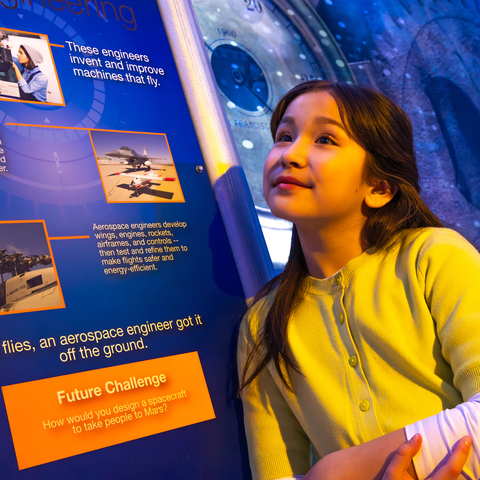 Girl viewing aerospace exhibit 