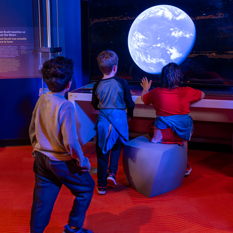 Kids looking at the Exploring Space exhibit gallery