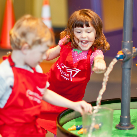 Girl and Boy playing in water table