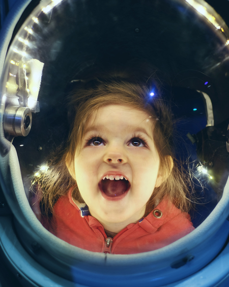 Young Child Exploring Space Suit