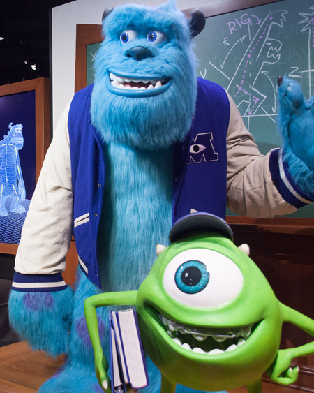 Family looking at Monsters U exhibit within Pixar