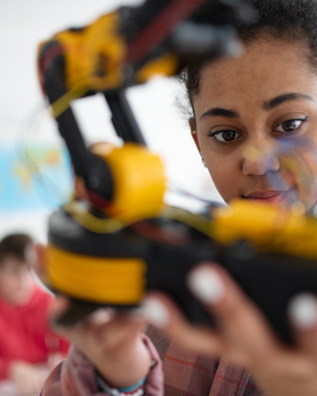 Teen playing with robotics in class