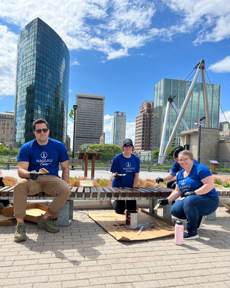 Group of volunteers painting bench