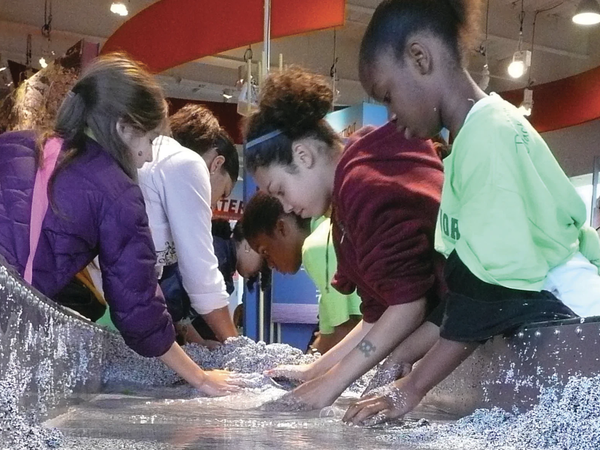 Kids playing at the stream table