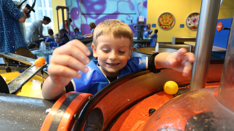 KidSpace - Boy playing with watertable